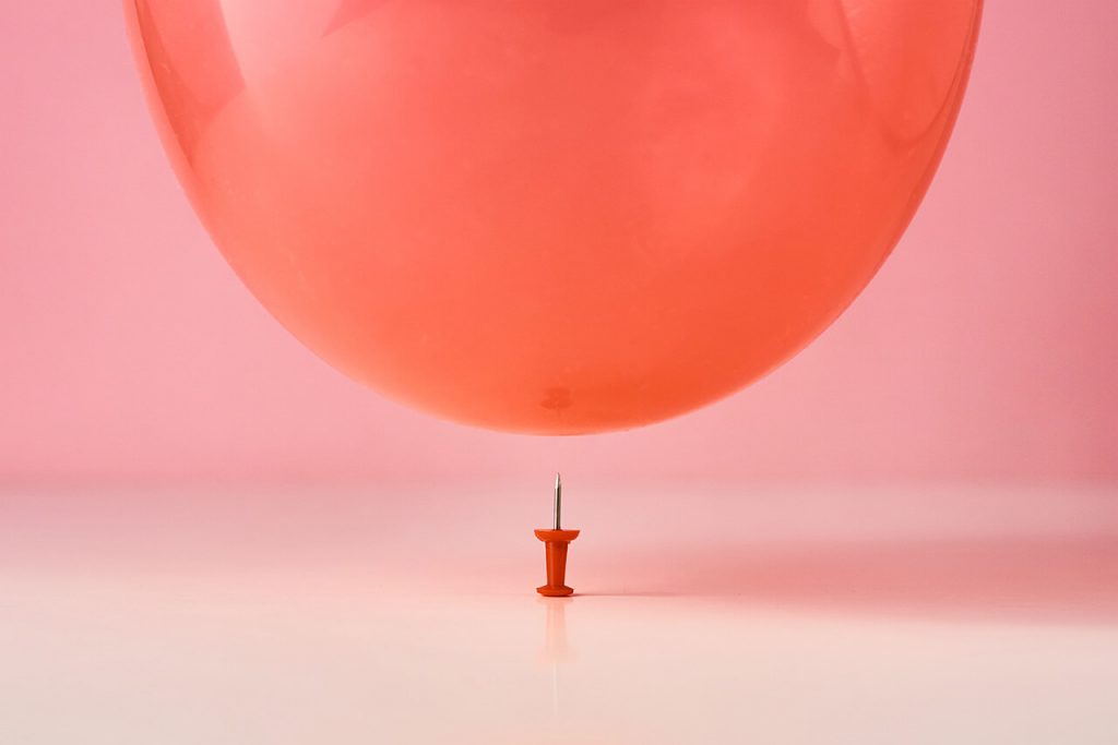 Pin on the verge of popping a baloon