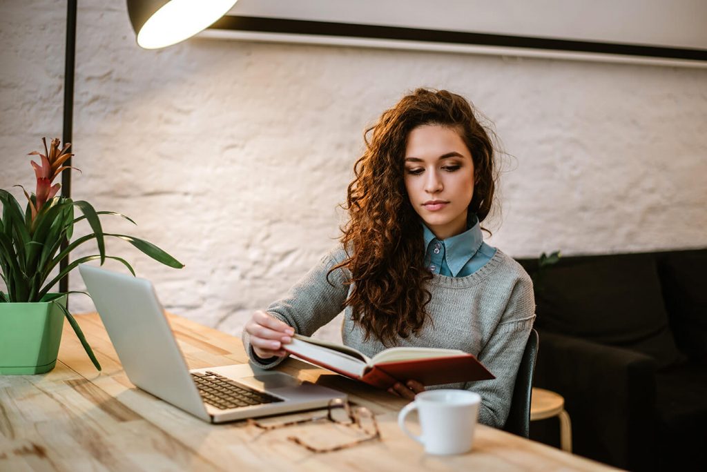 A young business woman planning at her desk