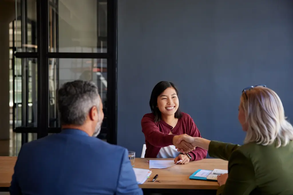 A woman working together with two partners